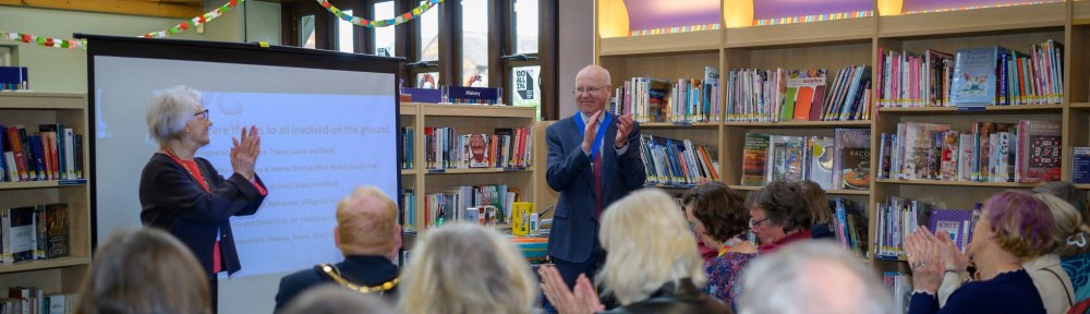People clapping in the library at the launch celebration.